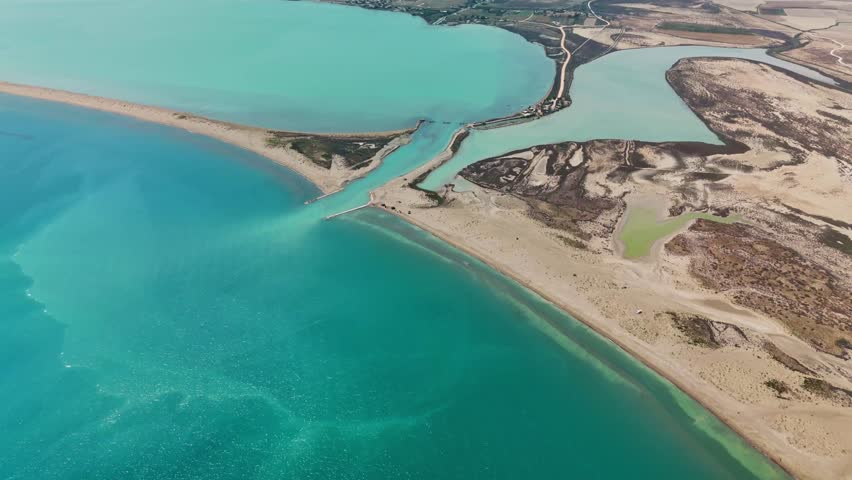 Aerial view of vibrant coastal lagoon with sandy beach and turquoise waters