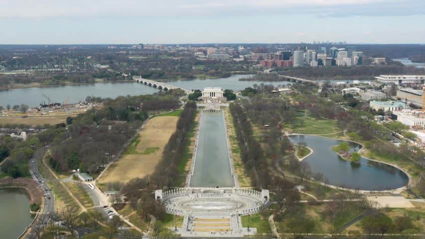 Wide aerial static view of National Mall, Lincoln Memorial, reflecting pool in Washington, DC