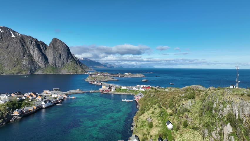 Reine toward Hamnoy with E10 bridges, stockfish racks, boathouses and turquoise sea