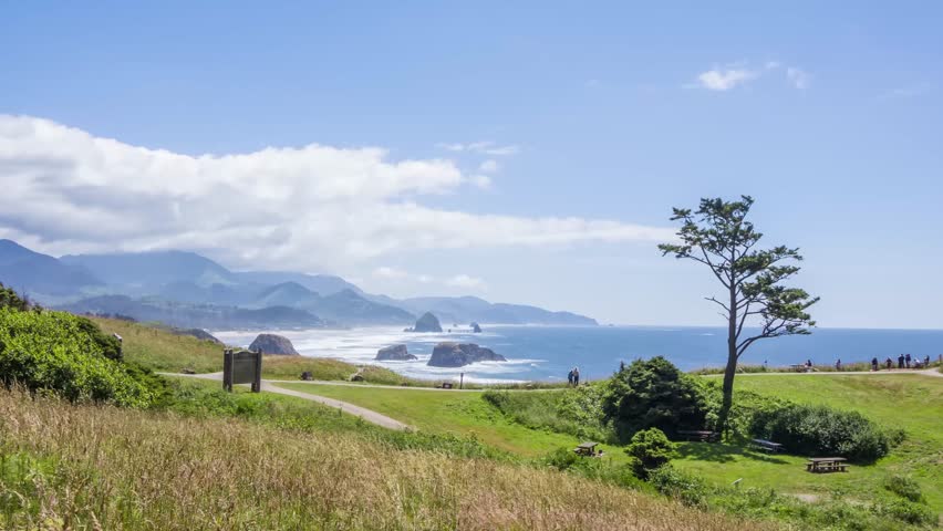 Footage depicts Ecola State Park, nestled between Seaside and Cannon Beach, showcasing coastal cliffs, forests, and beaches on the Pacific Northwest coast.