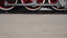 Men and women in black clothes with an umbrella walk through the station against the background of an old steam locomotive during the day. Legs and boots close-up - Powered by Shutterstock - Get 15% off with code: PIKWIZARD15