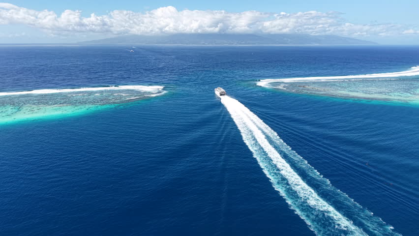 French Polynesia. Drone Shot of Ferry Boat Sailing Between Coral Reefs and Moorea and Tahiti Islands
