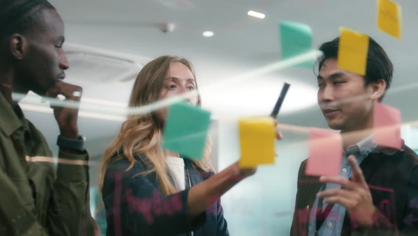 Group of Multicultural business people Meeting, Planning business strategy using sticky notes collaboration working together in boardroom at office workplace. Business brainstorming ideas concept.