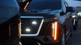 SUV Luxury black convoy driving through city streets at night with LED headlights illuminated. Vehicles appear as part of a formal security escort or wedding procession. Modern cars of protection - Powered by Shutterstock - Get 15% off with code: PIKWIZARD15