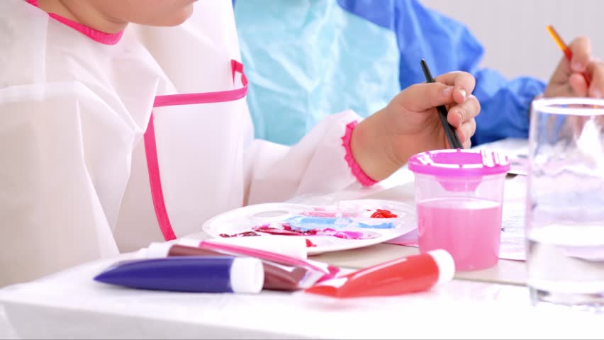 Kids engaged in art activity at elementary school artclass close up. Group children focused on creativity working with colorful materials in classroom. Creative pupils making handmade crafts together
