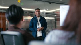 Confident Indian Businessman presenting ideas discussing strategy analysis financial data charts and graphs report on screen monitor with colleagues in boardroom office. Corporate Business meeting. - Powered by Shutterstock - Get 15% off with code: PIKWIZARD15