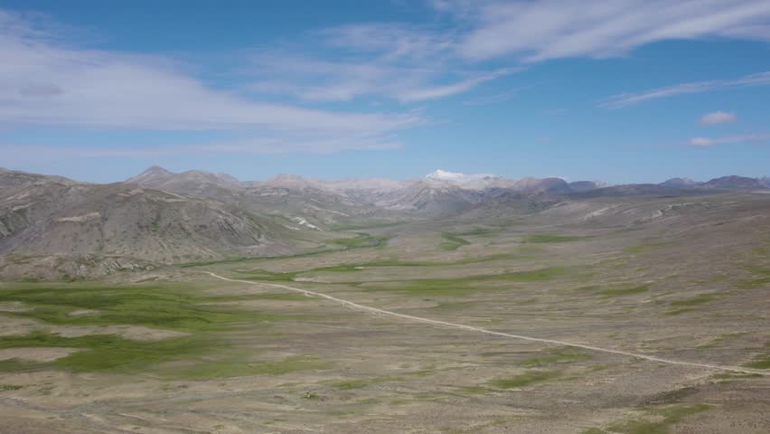 Expansive highland plains with distant snow peaks in Deosai National Park. Gilgit-Baltistan, Pakistan