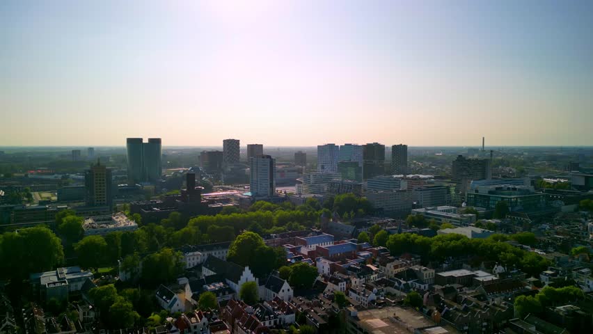 Aerial perspective of a bustling business center, highlighting contemporary buildings and greenery, illustrating the evolving urban scene in motion. business center Utrecht