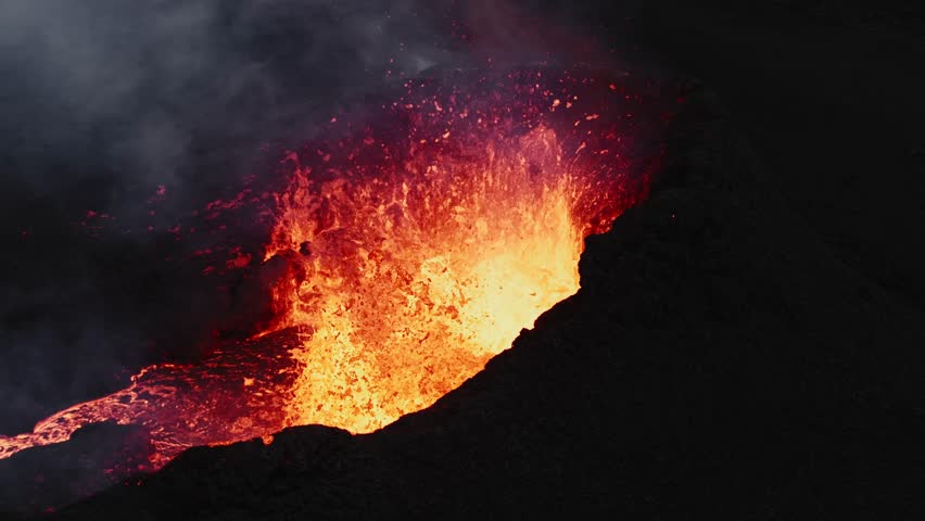 Steady shot of lava bubbling inside the crater, volcano eruption in Iceland - aerial 4k