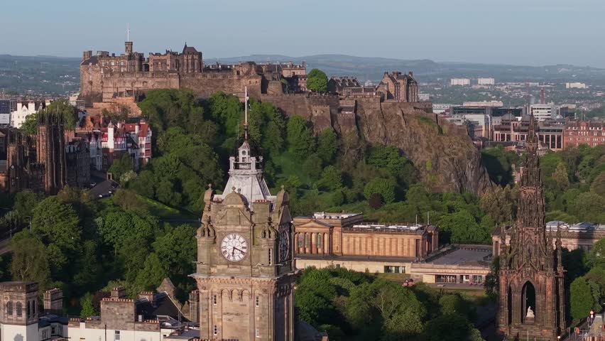 A cinematic drone journey showcasing Edinburgh’s iconic landmarks: the majestic Castle, elegant Balmoral Clock Tower, and the towering Scott Monument