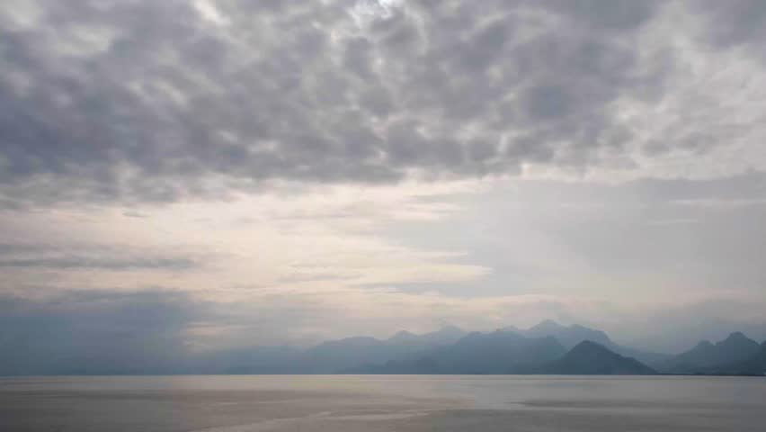 Time lapse of clouds moving over the sea. Dramatic sky and clouds over the sea in timelapse. Scenic seascape with clouds in motion. Fast moving clouds above sea. 