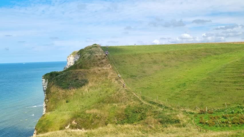 Coastal Cliffs and Verdant Hills Overlooking the Blue Ocean on a Sunny Day