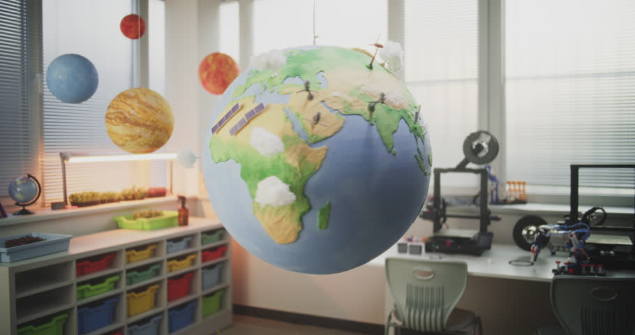Modern STEM Classroom: Rotating Earth Model with Miniature 3D Models of Wind Turbines and Solar Panels. Globe for Studying Technology of Renewable and Green Energy During Science Lesson. Dolly Shot.