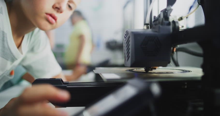 Close Up of Elementary School Boy Using 3D Printer Touchscreen, Learning Advanced Automated 3D Printing During Programming Lesson. Smart Young Boy Studying Technology. Interactive STEM Education.