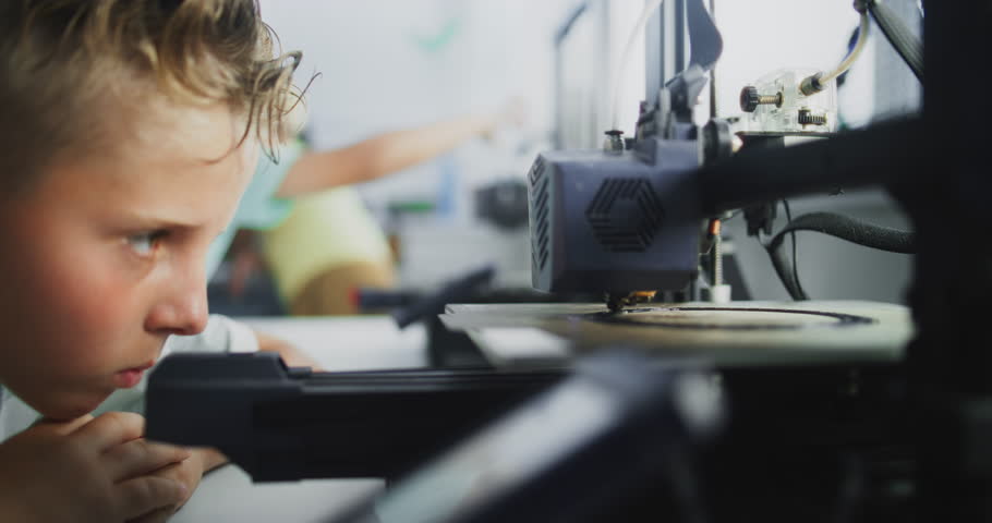 Close Up of Elementary School Boy Using 3D Printer Touchscreen, Learning Advanced Automated 3D Printing During Programming Lesson. Smart Young Boy Studying Technology. Interactive STEM Education.