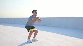  Fitness enthusiast performs squats with resistance band, showcasing strength and determination during workout session - Powered by Shutterstock - Get 15% off with code: PIKWIZARD15