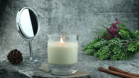 nice burning luxury aromatic scented candle glass is on stone table with a few rocks and background of grey stone wall in bed room to creat relax and romantic moment for lovers on Valentine day - Powered by Shutterstock - Get 15% off with code: PIKWIZARD15