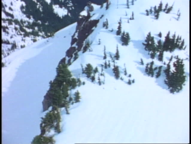 Aerial of Mount Rainer, POV, passing snow cliffs, Mount Rainer National Park