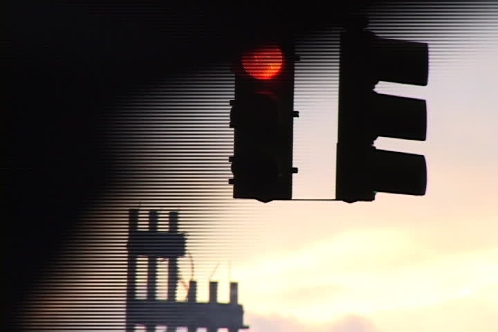 NEW YORK CITY - SEPTEMBER 28, 2001: Close up of traffic light, with silhouette of World Trade Center remains and sunset in background.