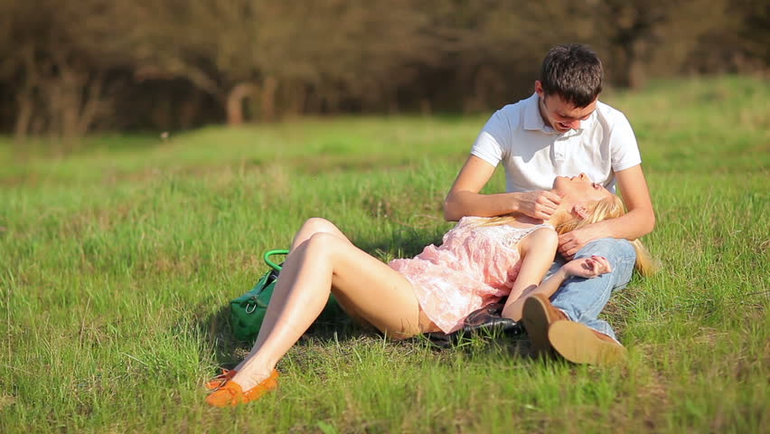 Young couple sitting on ground in park