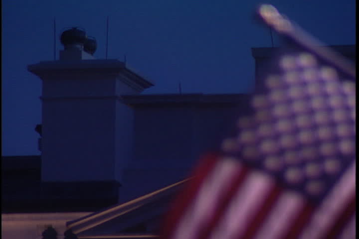 WASHINGTON, D.C. - CIRCA OCTOBER 2001: MS White House roof with American flag billowing in foreground.
