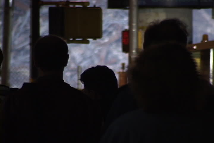 NEW YORK CITY - SEPTEMBER 28, 2001: Silhouettes of spectators in front of World Trade Center rubble.