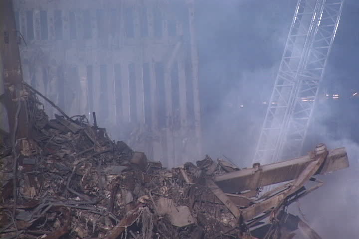NEW YORK CITY - SEPTEMBER 28, 2001: Smoke rising from rubble pile with remains of World Trade Center structure in background.