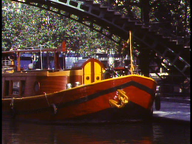 Paris, France, Barge on canals of Paris, red and yellow, medium close up, zoom out wide