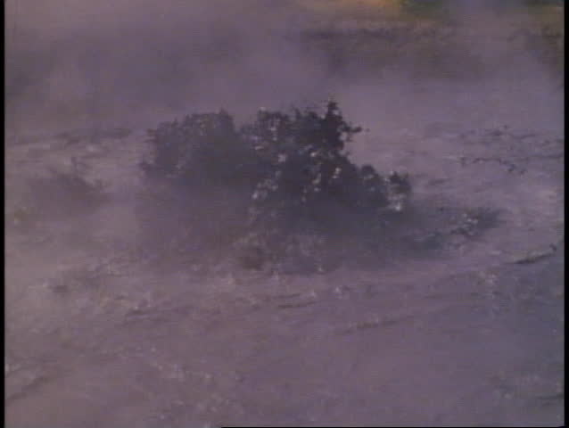 Yellowstone National Park, black pool, bubbling black water in center, close up
