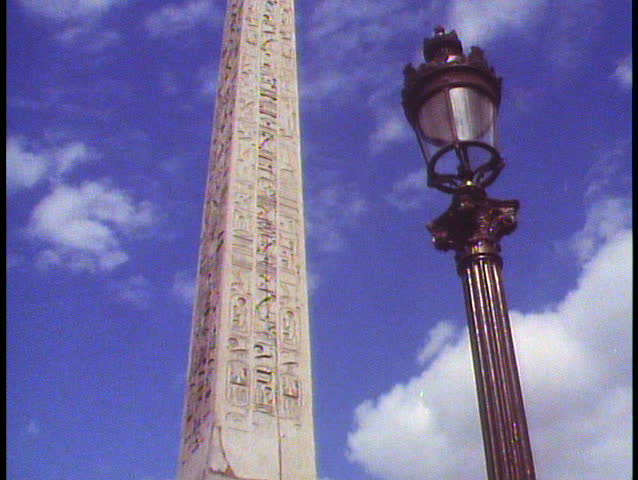 Paris, France, Place de la Concorde, medium close up, tilt up of obelisk, street lamp in foreground