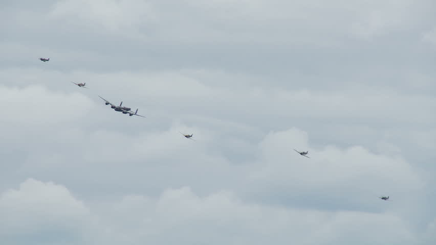 Avro Lancaster bomber flying in formation with RAF Spitfires and Hurricanes from
