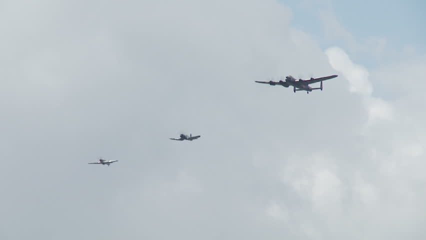 Avro Lancaster bomber flying in formation with an RAF Spitfire and a US Navy