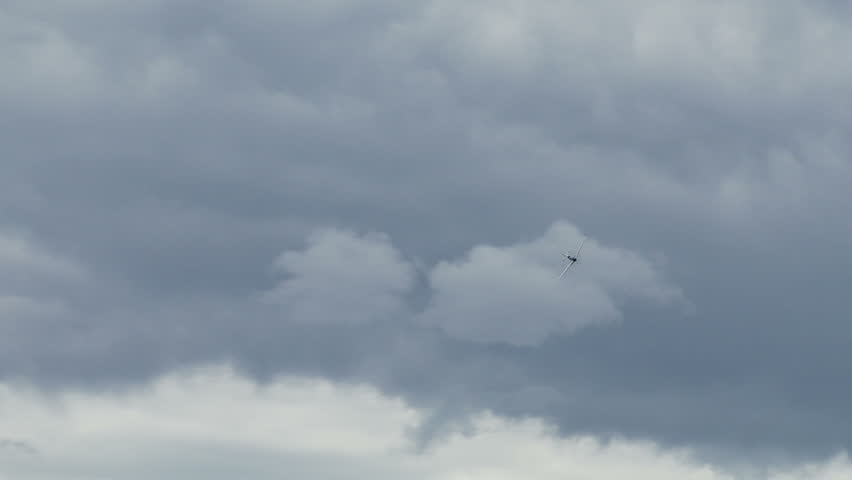 Two clips of a historic USAF P-51 Mustang, in flight and landing on airfield.
