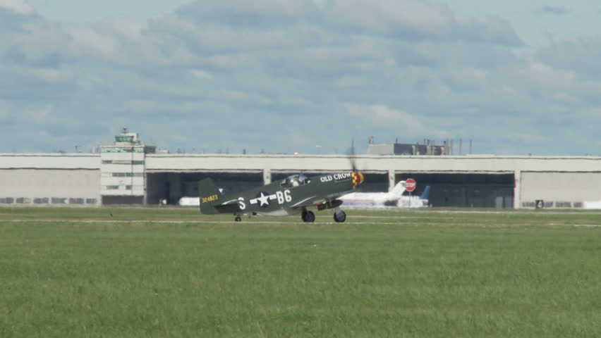 Historic USAF P-51 Mustang taxiing on airfield.