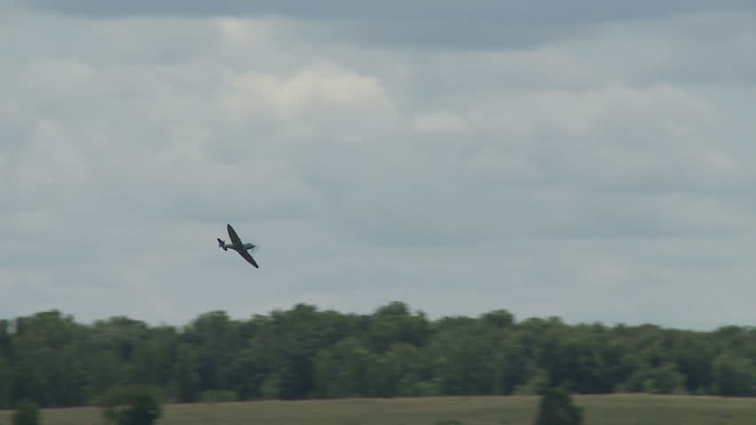 Supermarine Spitfire fighter plane from World War II flying, passing over an