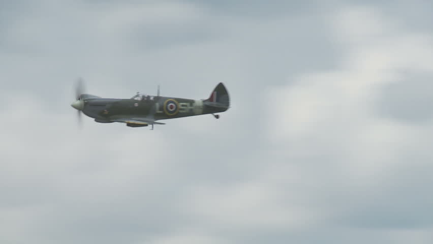 Supermarine Spitfire fighter plane from World War II flying, passing a formation