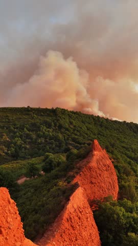 forest fire in the mountains in Spain, global warming concept, drought in Spain, smoke and wildfire drone shot, burnt woods in Las Medulas, climate change. 