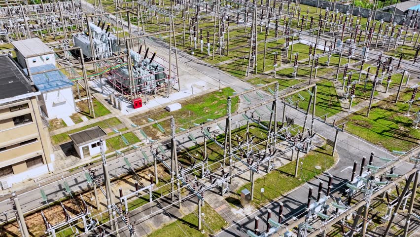 aerial view electric substation, pylon power line high voltage, electrical transmission field,