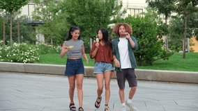 Group of young cheerful multi ethnic friends enjoying ice cream while walking together in a city park - Powered by Shutterstock - Get 15% off with code: PIKWIZARD15