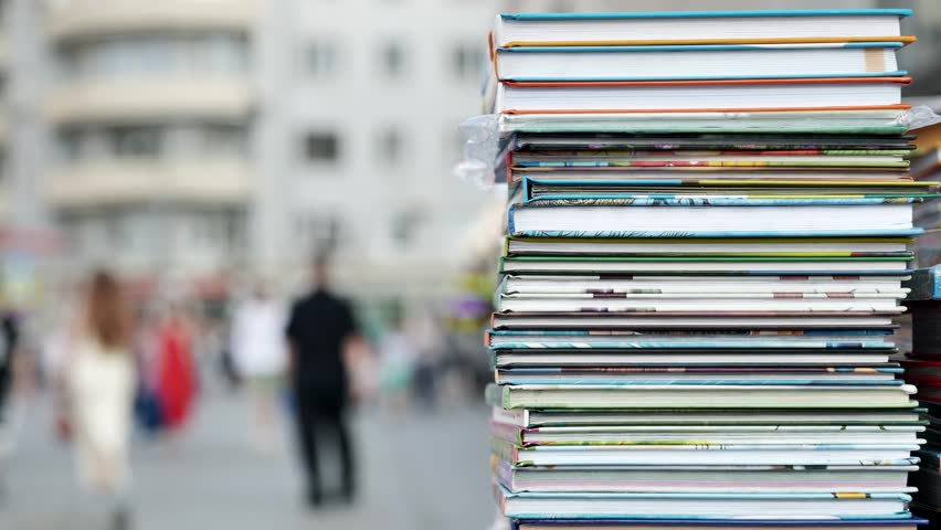Stack of colorful books standing in a city street