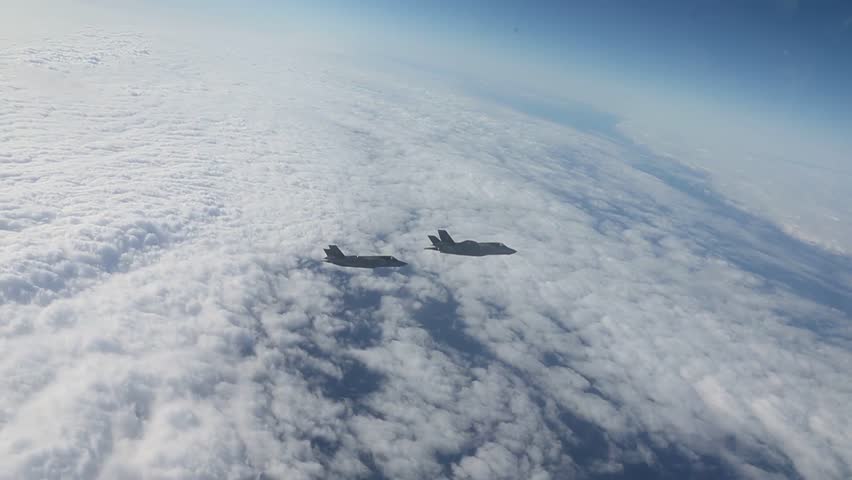 U.S. Marine Corps F-35B Lightning II aircraft assigned to Marine Fighter Attack Squadron (VMFA) 242, 31st Marine Expeditionary Unit, fly over the amphibious assault ship USS America (LHA 6).
