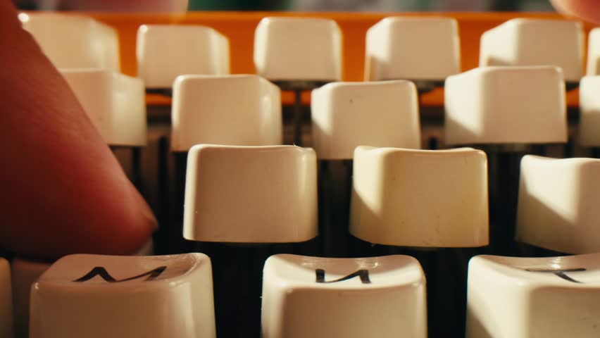 Typewriter close up, writer Typing on an old vintage antique typewriter - close up of hands on keys