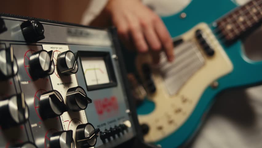 Bass guitar being played in a recording studio, rehearsal room, man playing jazz close up macro, vintage recording equipment