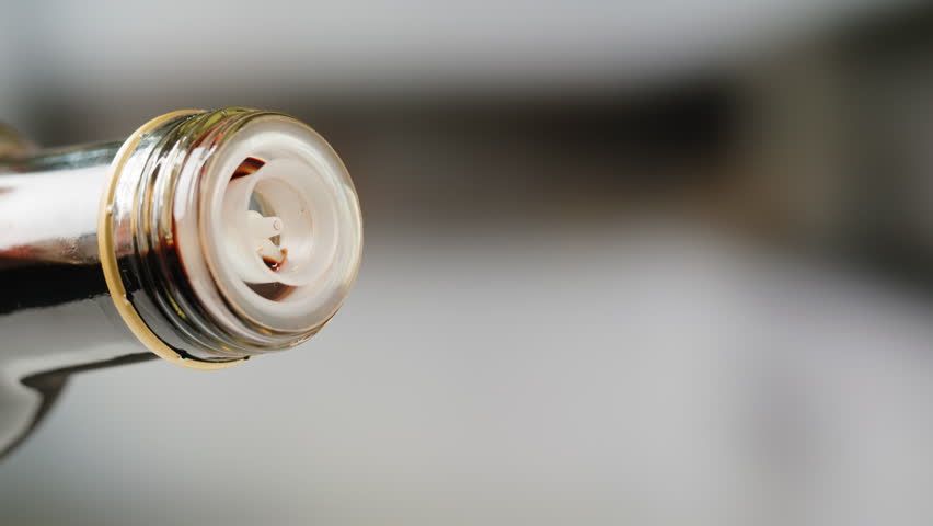 Asian Japanese soy sauce, Dark brown soy sauce pouring down into the glass bowl close up