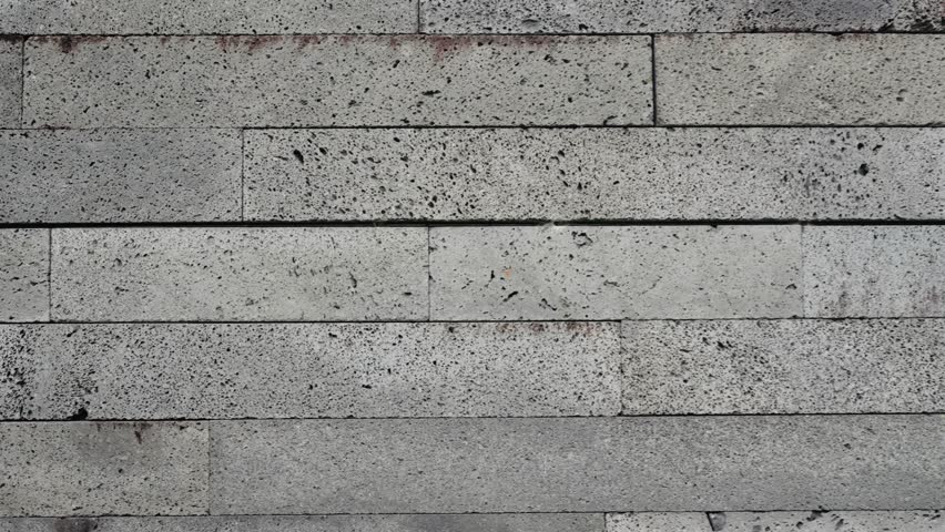 Detailed close-up image of a concrete stone brick wall texture, perfect for backgrounds, construction themes, or design projects. Close-Up of Concrete Stone Brick Wall Texture for Background - Powered by Shutterstock - Get 15% off with code: PIKWIZARD15