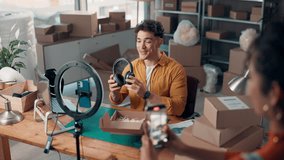 Live streaming. headphones and ecommerce with man in warehouse for dropshipping, product and review. Broadcast, social media promotion and tech supplier with people in factory for distribution - Powered by Shutterstock - Get 15% off with code: PIKWIZARD15