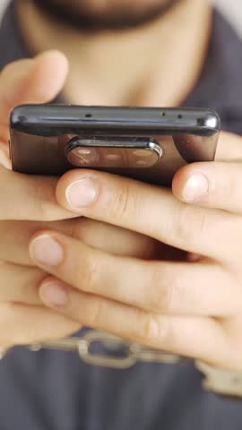 Smartphone and social network addiction concept. Young male using smartphone scrolling compulsively