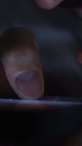 Smartphone and social network addiction concept. Hands using smartphone in bed at night