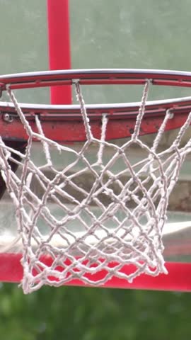 Slow Motion of Street Basketball, Closeup Of Ball Going Into Basket. A Throw In A Basketball Ring, Falls Into Hoop	