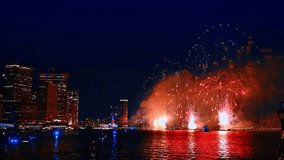 Spectacular firework flashes over the riverscape at night. New York celebrating the holiday. Perspective from the waterscape. - Powered by Shutterstock - Get 15% off with code: PIKWIZARD15